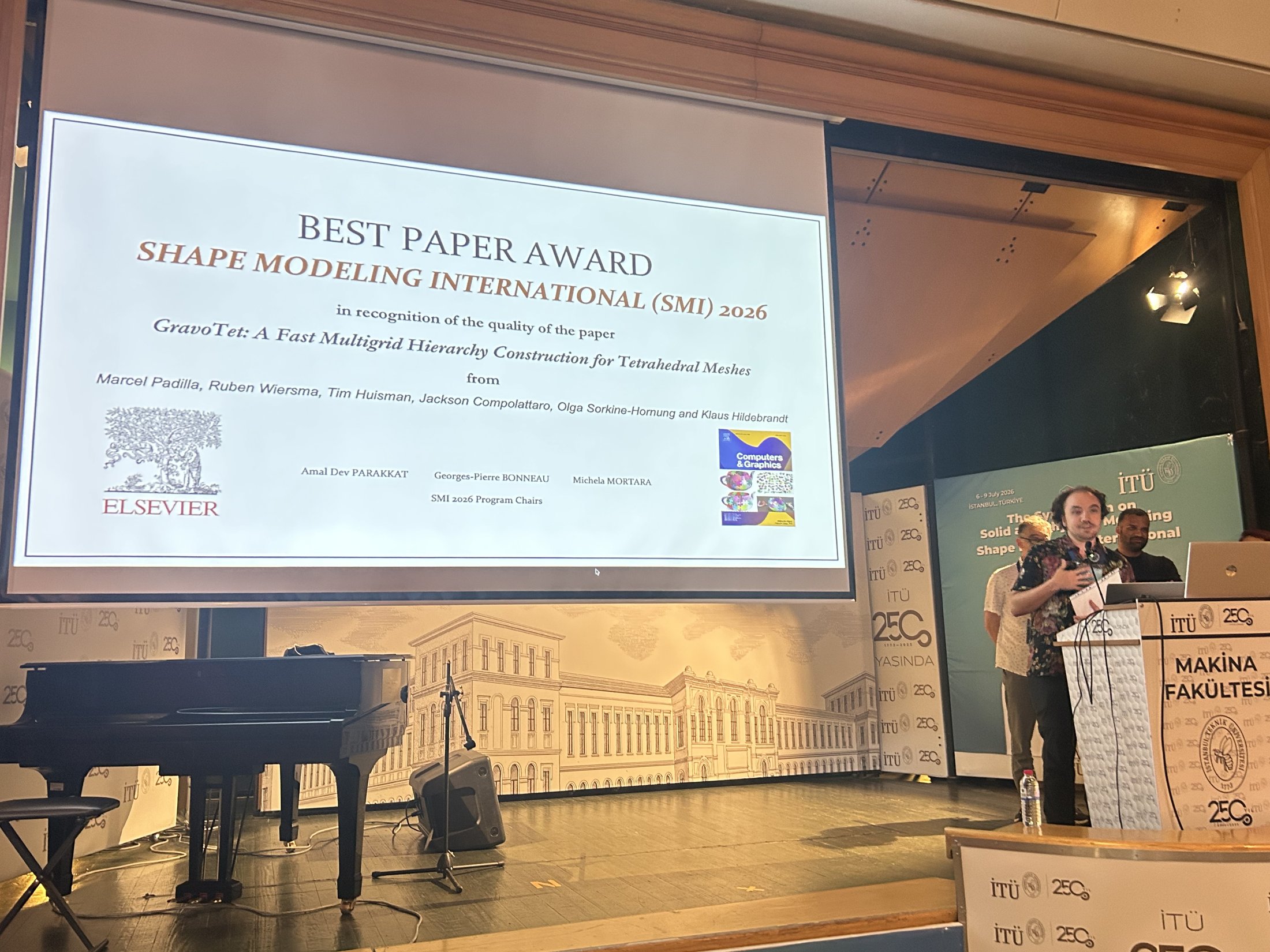 Receiving the Best Paper Award on stage at SMI 2026
